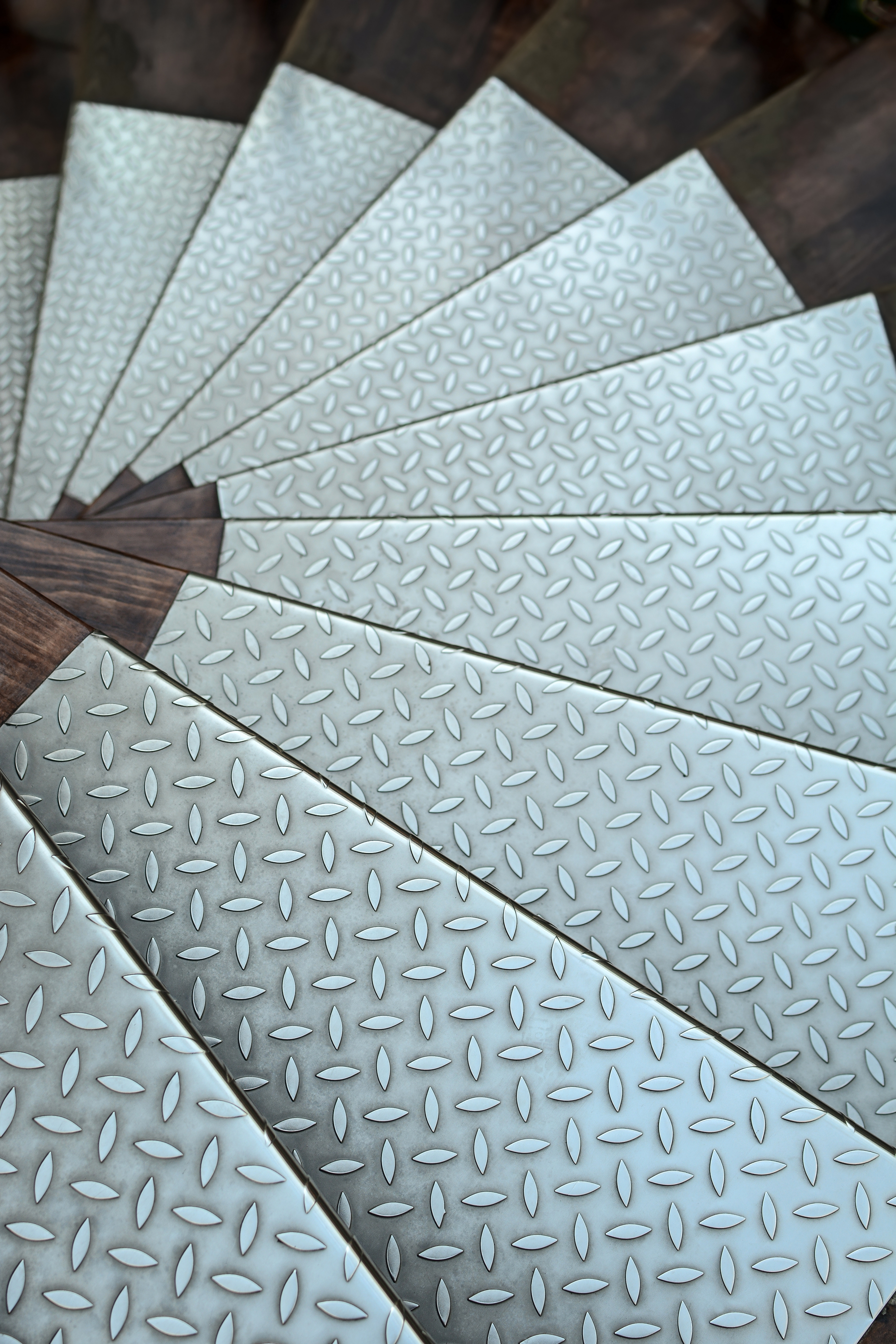 shutterstock_2214604815_background abstract metallic stainless steel floor. Close-up of a spiral staircase lined with steel plates. metal texture.jpg